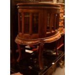 A reproduction walnut vitrine cabinet with sixteen glazed display panels,