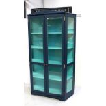 A painted display cabinet with pair of glazed doors.