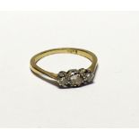 An 18ct gold ladies' ring set with three graduating diamonds, size P, approx 2.6g.