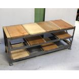A large rectangular side table inset with various specimen timbers, on metal frame, 134 x 44cm.