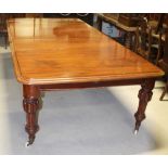 A late 19th/early 20th century mahogany wind-out dining table with two central leaves on turned