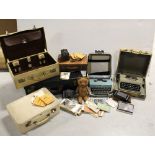 A large black vintage suitcase and a vintage cream suitcase, a small brown leather document case,