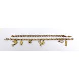 A 9ct gold charm bracelet with eight charms to include a small comb, stork with baby,