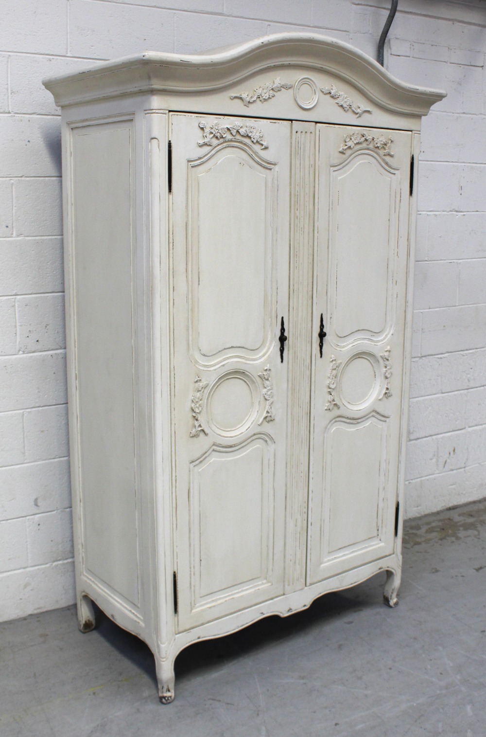 A contemporary ivory painted French armoire-style wardrobe,