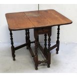 An oak drop-leaf table with end drawer, on bobbin-turned gateleg supports, length 75cm.