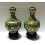 A pair of Oriental blue ground cloisonné baluster vases, height 19cm, with wooden bases (2).