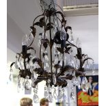 A five-branch ornate electrolier bronze-effect leaf decoration and cut glass drops, 60cm.