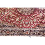 A red ground Keshan carpet, 280 x 200cm.