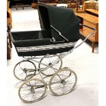 A vintage Marmet pram, dark green body and white trim, length inclusive of handle 123cm.