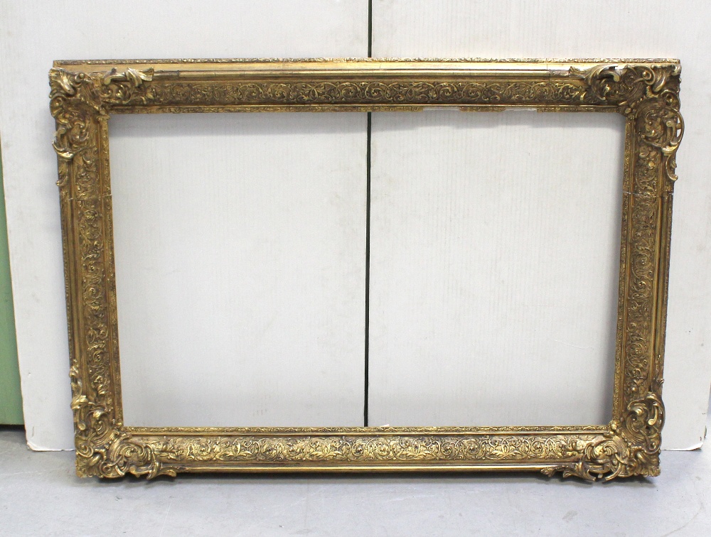 An ornate gilt frame, 136 x 95cm (af).