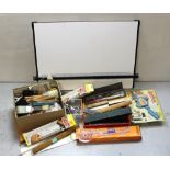 A selection of artist's equipment to include precision drawing instruments, vintage rulers,