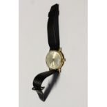 Garrard; a gentlemen's yellow metal wristwatch, dial set with Arabic numerals and date aperture.