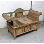 An Indian hardwood carved and panelled window seat with carved and turned back rail,