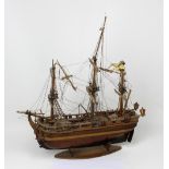 A late 19th century model sailing ship on an oval wooden stand, length 46cm.