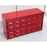 A rectangular metal chest with twenty-four filing drawers, re-sprayed in pillar box red, 53 x 92cm.