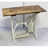 A Singer sewing machine converted to a table with plank top and white-painted base, 91.5 x 44cm.