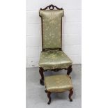 A 19th century walnut carved prie-dieu chair and a similar footstool,