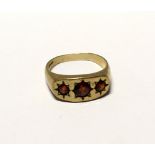 A 9ct gold gentlemen's dress ring set with three garnets, size Y, approx 6.4g.
