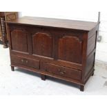 A late 18th/early 19th century oak chest, hinged top above three carved panels, two drawers to base,