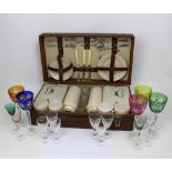 A vintage picnic set with cutlery, plates, saucers,