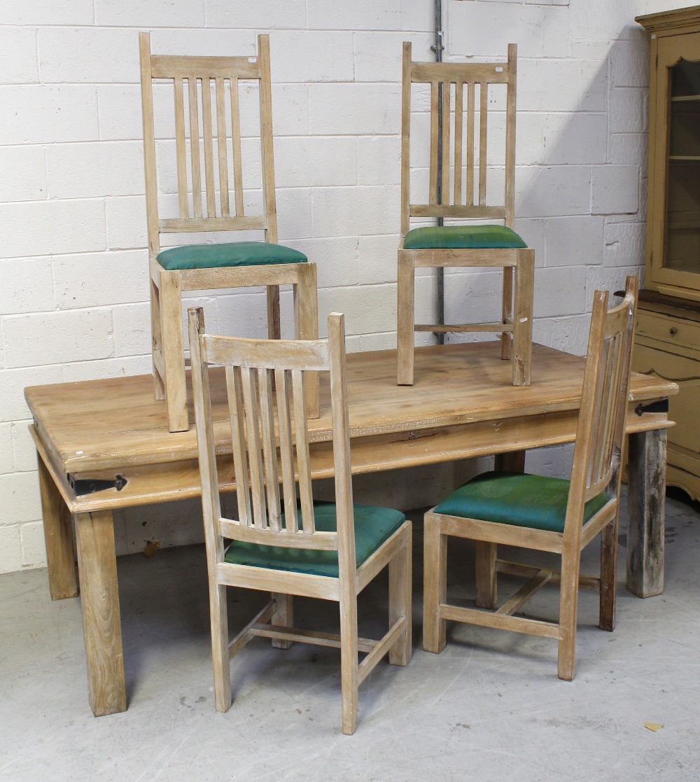 A contemporary stripped pine rectangular dining table on block supports,