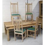 A contemporary stripped pine rectangular dining table on block supports,