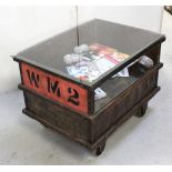 An upcycled trolley salvaged from a woollen mill with glass top above undertier, 82 x 61cm.