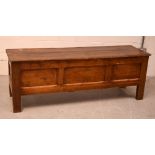 A 19th century Continental pine coffer, with hinged lid above panelled carcass,