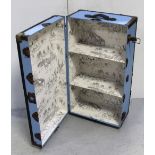 A vintage metal-bound travel trunk, re-painted exterior and re-papered interior,