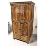 A late 19th/early 20th century hardwood carved cabinet, carved frieze above cupboard doors,