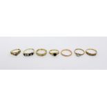 Seven 9ct gold dress rings to include a ladies' wedding band, size M,