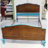 A c1950s walnut bed frame, re-painted with turquoise trim.