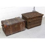 A large vintage wicker travel basket with rope handles to either side,