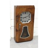 An Art Deco walnut-cased eight-day wall clock, the octagonal silvered dial set with Arabic numerals,