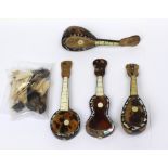 Four miniature tortoiseshell mandolins/guitars with bag of loose fittings, mounts,