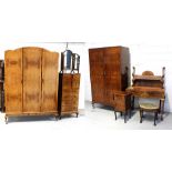 A quantity of bedroom furniture to include a walnut serpentine-front dressing table on cabriole