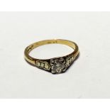 An 18ct gold ring set with a solitaire diamond in platinum, size K, approx 2.2g.