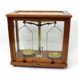 A glass-cased set of brass weighing scales, Phillip Harris Ltd.