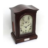 An early 20th century stained mahogany cased eight-day mantel clock,