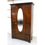 An Edwardian inlaid mahogany single mirror door wardrobe with inlay to panels either side,