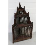 An Indian hardwood corner unit, four shelves with decorative lattice sides, 124 x 68cm.