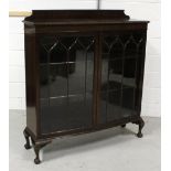 A mid-20th century display cabinet, two glazed doors with two interior shelves,