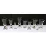 Nine late 19th/early 20th century glass dispensary measures for ounces and drams (9).