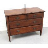 An early 20th century oak chest of two short over two long drawers with tapering supports to