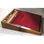 A 19th century mahogany and brass inlaid writing slope, with fitted interior and red velvet lining,