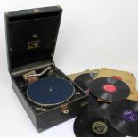 A 'His Master's Voice' portable gramophone with a small quantity of 78s.