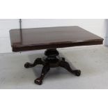 A late 19th/early 20th century mahogany rectangular dining table with carved tapering column and