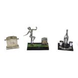 Three Art Deco table lighters; a nude female dancing figure on plinth base, height 16cm,