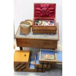 A retro sewing table with embroidered fabric top, a smaller folding sewing box,