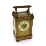 A c1900 brass carriage clock, the white enamel dial set with Arabic numerals,